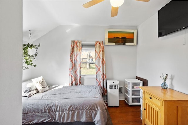 bedroom with a ceiling fan, lofted ceiling, and dark wood finished floors