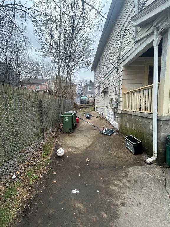 view of home's exterior with fence and a patio