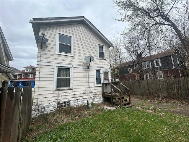 rear view of house with fence