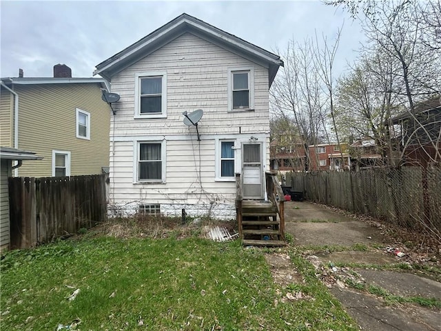 back of property featuring a fenced backyard