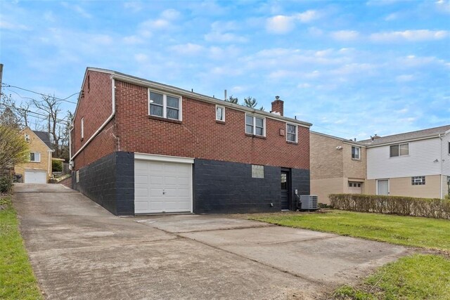 647 Northcrest Dr, Brookline, PA 15226 - back of property featuring a chimney, driveway, an attached garage, brick siding, and central AC