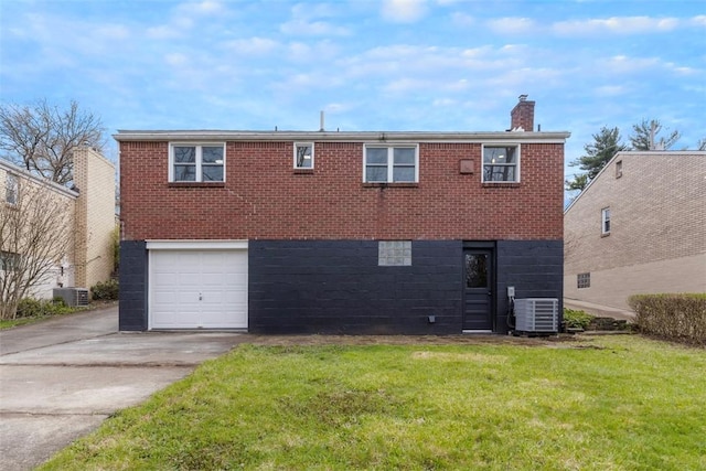 647 Northcrest Dr, Brookline, PA 15226 - back of house with central air condition unit, a lawn, brick siding, an attached garage, and driveway