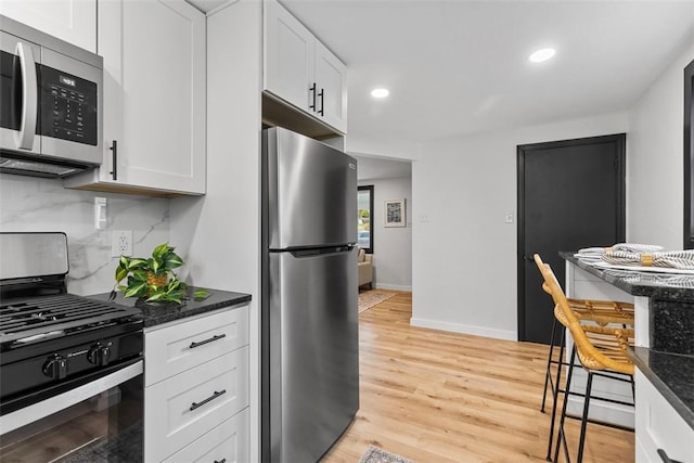 647 Northcrest Dr, Brookline, PA 15226 - kitchen featuring light wood-style floors, tasteful backsplash, white cabinets, recessed lighting, and stainless steel appliances