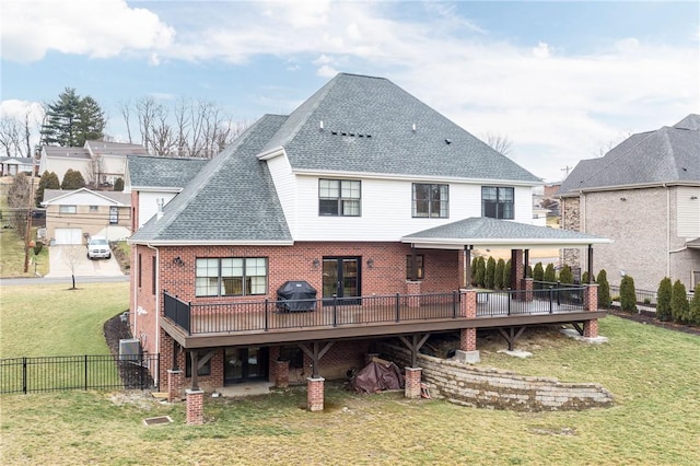 1371 Carnahan Rd, Banksville/Westwood, PA 15220 - rear view of house featuring roof with shingles, brick siding, a deck, fence, and a lawn