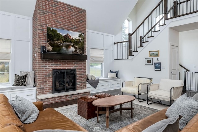 1371 Carnahan Rd, Banksville/Westwood, PA 15220 - living room featuring stairs, a high ceiling, a fireplace, and a healthy amount of sunlight