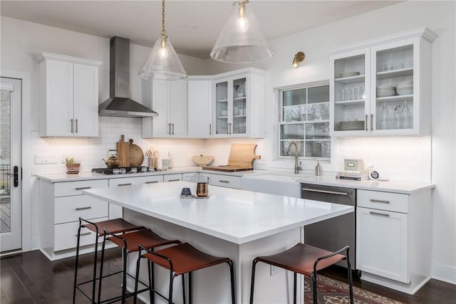 1371 Carnahan Rd, Banksville/Westwood, PA 15220 - kitchen featuring wall chimney exhaust hood, a sink, a kitchen breakfast bar, gas stovetop, and stainless steel dishwasher