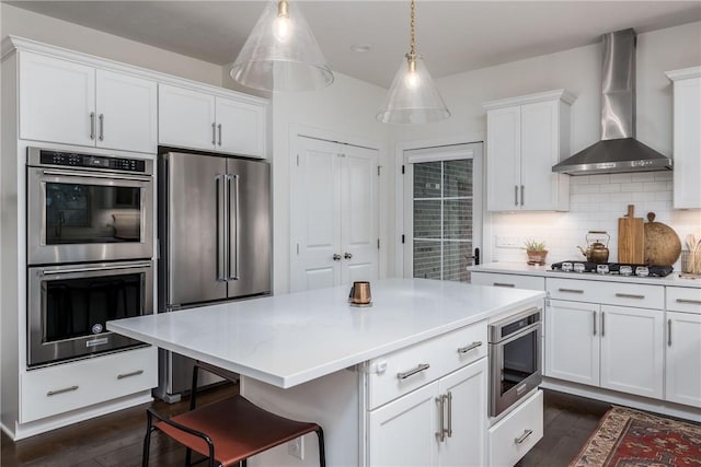 1371 Carnahan Rd, Banksville/Westwood, PA 15220 - kitchen with white cabinets, wall chimney range hood, light countertops, dark wood-style floors, and stainless steel appliances
