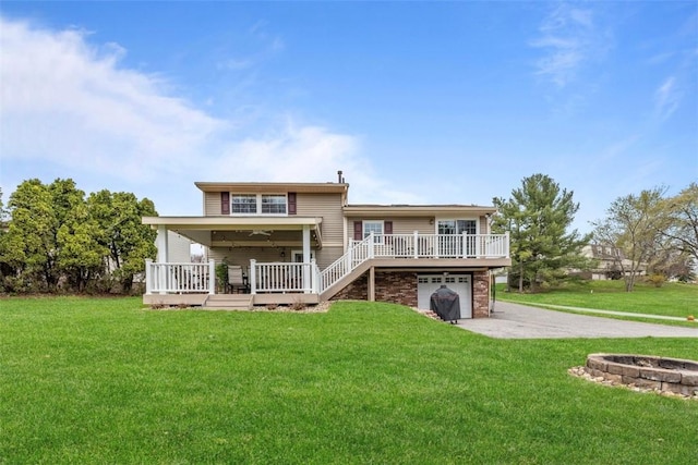 123 Summit Ridge Dr, South Fayette, PA 15017 - rear view of house featuring an attached garage, driveway, a wooden deck, and a lawn