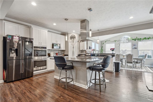 423 Labrador Ln, Jefferson Hills, PA 15025 - kitchen with island exhaust hood, dark wood-type flooring, appliances with stainless steel finishes, and crown molding