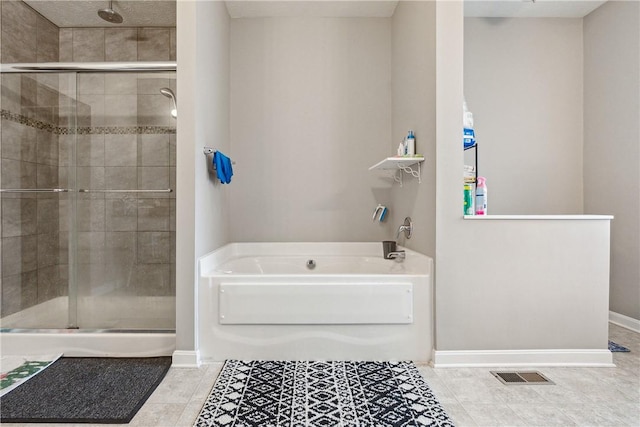 423 Labrador Ln, Jefferson Hills, PA 15025 - bathroom featuring baseboards, a garden tub, tile patterned floors, and a stall shower