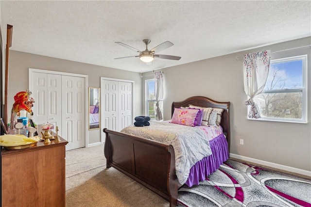 423 Labrador Ln, Jefferson Hills, PA 15025 - bedroom with a ceiling fan, a textured ceiling, multiple closets, carpet floors, and baseboards