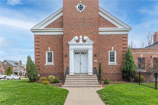 4721 Stanton Ave, Stanton Heights, PA 15201 - view of front of house with brick siding, a front yard, and fence