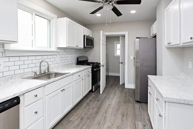 2017 Leishman, Arnold, PA 15068 - kitchen with a sink, decorative backsplash, appliances with stainless steel finishes, and white cabinetry