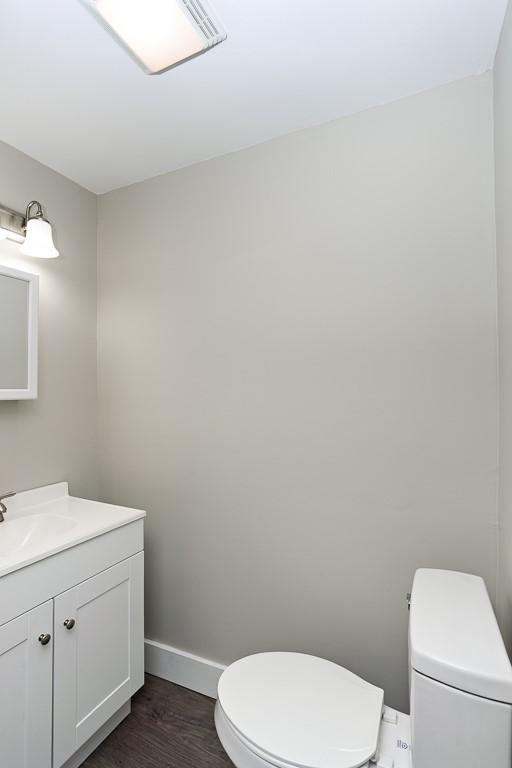 2017 Leishman, Arnold, PA 15068 - half bath featuring toilet, vanity, wood finished floors, and baseboards