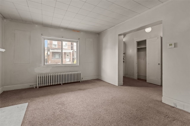 826 Collins Ave, Highland Park, PA 15206 - interior space featuring baseboards, radiator, and carpet floors