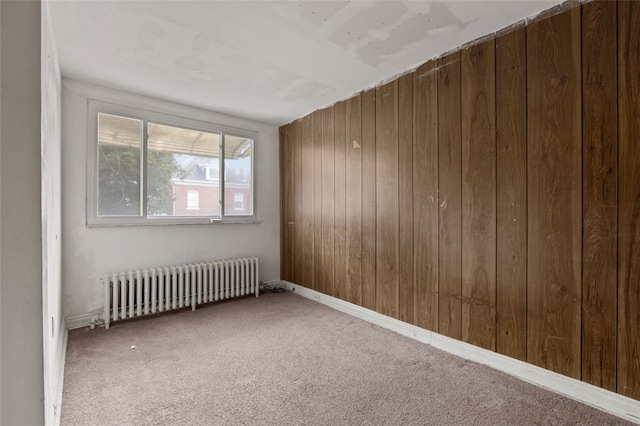 826 Collins Ave, Highland Park, PA 15206 - spare room with wood walls, radiator, and carpet floors
