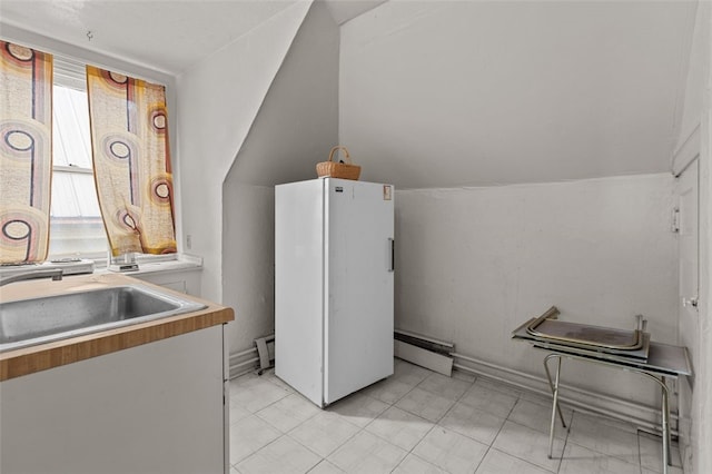 826 Collins Ave, Highland Park, PA 15206 - laundry room with a baseboard radiator, light tile patterned floors, and a sink