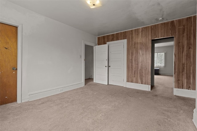 826 Collins Ave, Highland Park, PA 15206 - unfurnished bedroom with wooden walls, baseboards, and carpet
