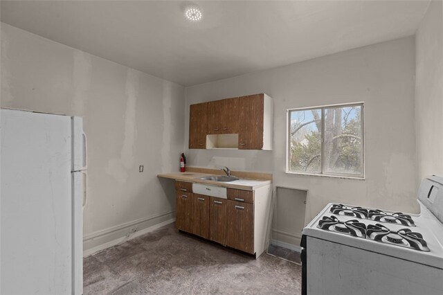 826 Collins Ave, Highland Park, PA 15206 - kitchen featuring a sink, light countertops, white appliances, and baseboards