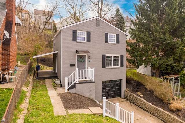 2011 Woodward Ave, Brookline, PA 15226 - view of front of home with brick siding, driveway, and an attached garage