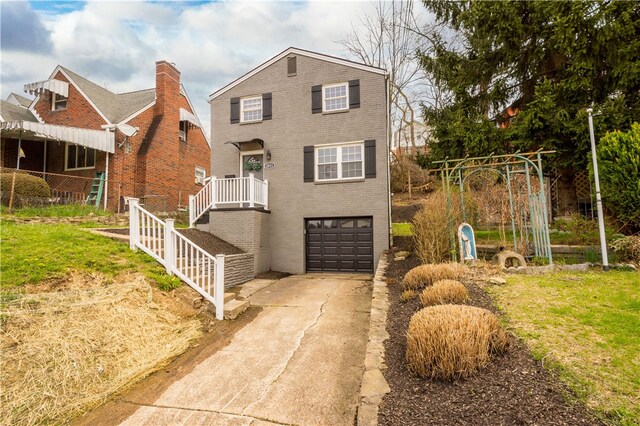 2011 Woodward Ave, Brookline, PA 15226 - view of front of home with an attached garage, concrete driveway, stairs, and brick siding