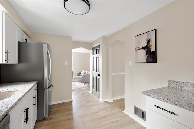 2011 Woodward Ave, Brookline, PA 15226 - kitchen featuring light wood-style flooring, white cabinets, light stone countertops, visible vents, and dishwashing machine