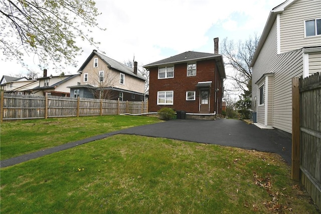 2714 Graham Blvd, Wilkinsburg, PA 15235 - rear view of property with a patio, a yard, and a fenced backyard