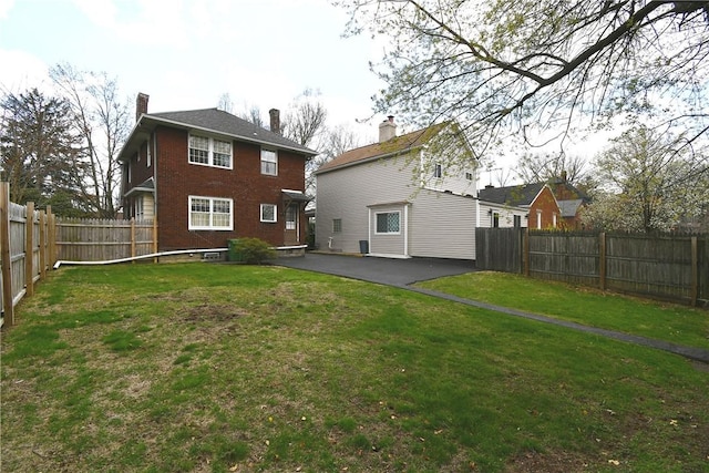 2714 Graham Blvd, Wilkinsburg, PA 15235 - rear view of property featuring a patio, a fenced backyard, and a lawn