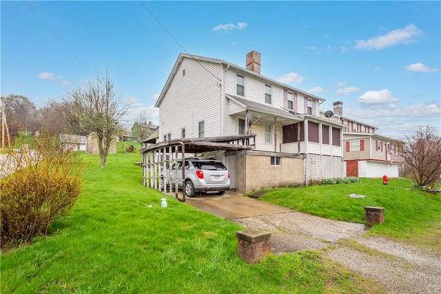 16 Fishpot Rd, Centerville, PA 15368 - view of side of home featuring a carport, a chimney, concrete driveway, and a yard