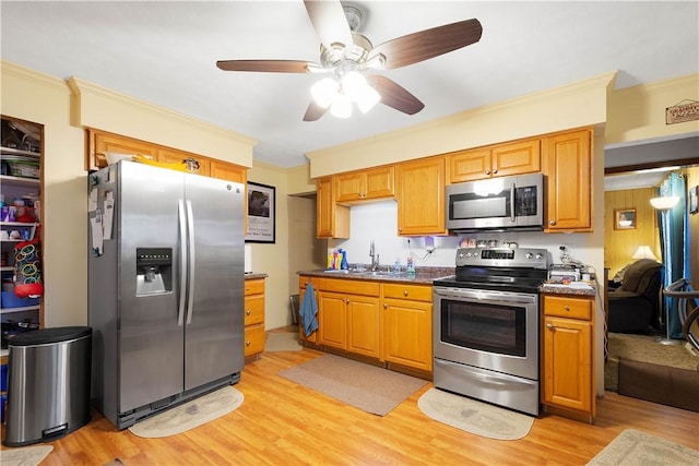 16 Fishpot Rd, Centerville, PA 15368 - kitchen with light wood-type flooring, ornamental molding, dark countertops, ceiling fan, and stainless steel appliances