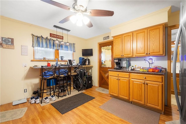 16 Fishpot Rd, Centerville, PA 15368 - kitchen featuring brown cabinets, a ceiling fan, light wood-style floors, and crown molding
