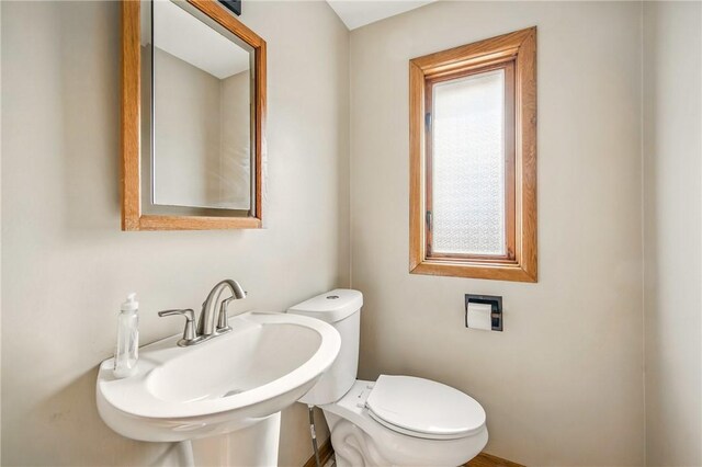 half bathroom with toilet and a sink