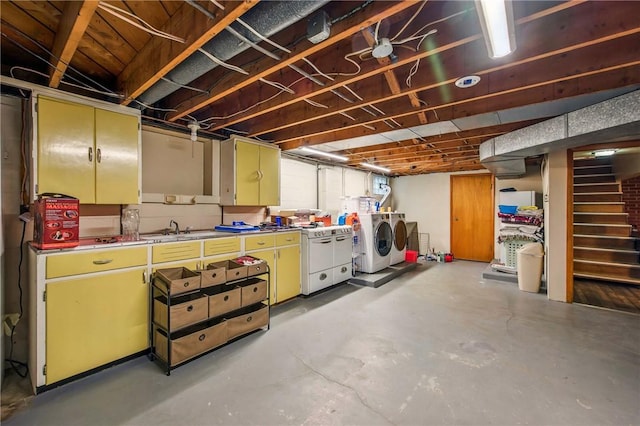 below grade area featuring stairway, separate washer and dryer, and a sink