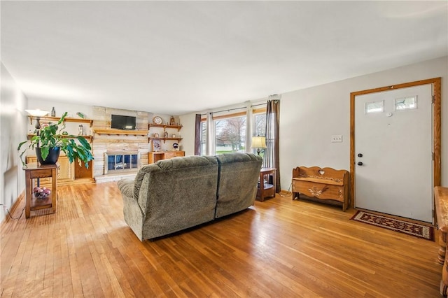 living area featuring a fireplace and light wood-style floors