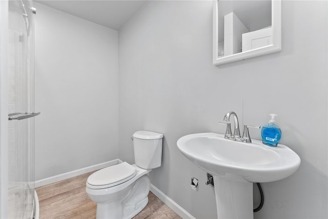 106 Morgan Dr, South Strabane, PA 15301 - bathroom with wood finished floors, toilet, and baseboards