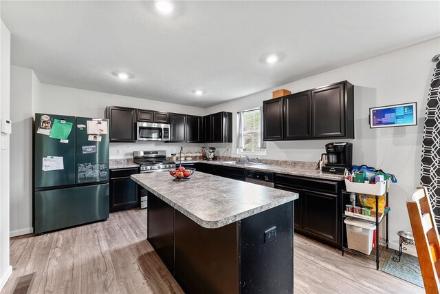 106 Morgan Dr, South Strabane, PA 15301 - kitchen with a center island, a sink, light wood-type flooring, visible vents, and appliances with stainless steel finishes