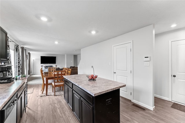 106 Morgan Dr, South Strabane, PA 15301 - kitchen featuring recessed lighting, light countertops, dark cabinetry, light wood-style floors, and a kitchen island