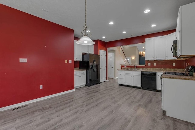kitchen with black appliances, light wood-style floors, baseboards, recessed lighting, and white cabinets