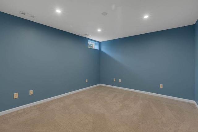 empty room with recessed lighting, light carpet, and baseboards
