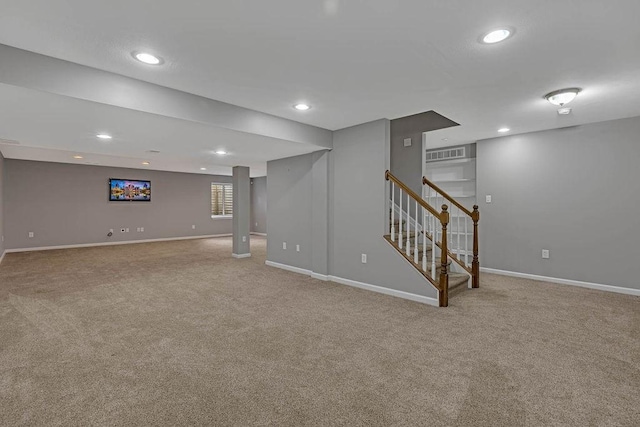 below grade area with carpet flooring, stairway, baseboards, and recessed lighting
