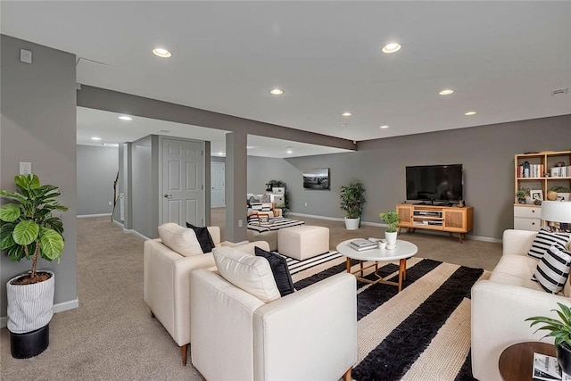 living area featuring light colored carpet, recessed lighting, and baseboards