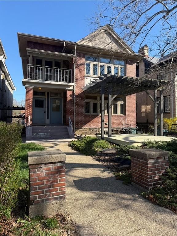6605 Woodwell St, Squirrel Hill, PA 15217 - multi unit property featuring a pergola, a balcony, brick siding, and a patio area