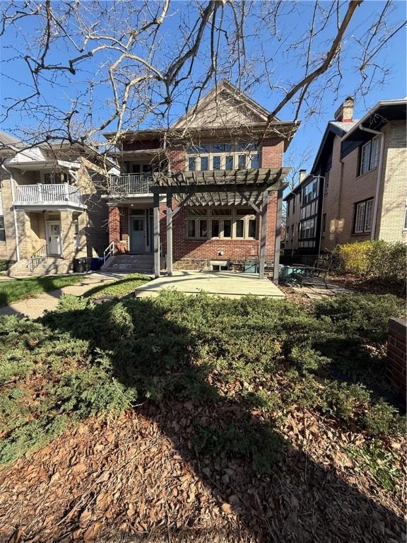 6605 Woodwell St, Squirrel Hill, PA 15217 - rear view of house with a patio area, brick siding, and a balcony