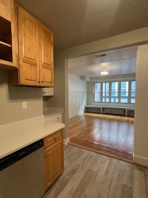 6605 Woodwell St, Squirrel Hill, PA 15217 - kitchen with light wood finished floors, light countertops, baseboards, visible vents, and dishwasher
