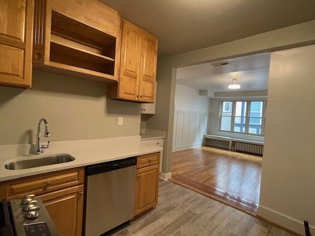 6605 Woodwell St, Squirrel Hill, PA 15217 - kitchen featuring stainless steel dishwasher, light wood-style flooring, a sink, visible vents, and light countertops