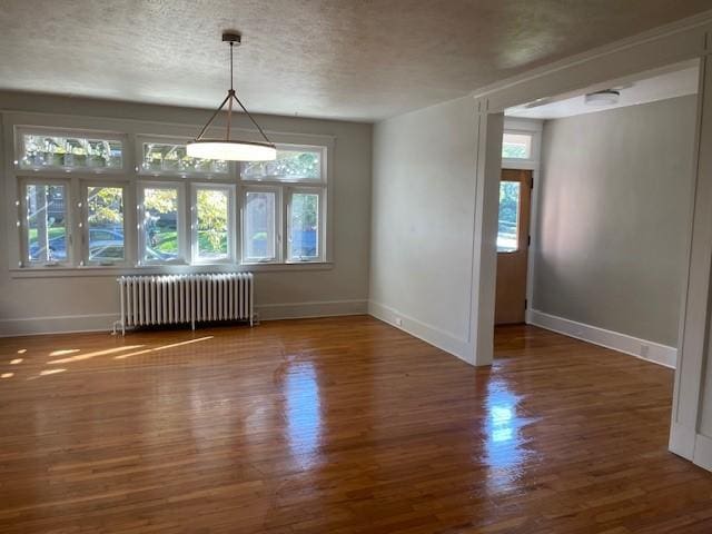 6605 Woodwell St, Squirrel Hill, PA 15217 - unfurnished dining area with a wealth of natural light, radiator heating unit, wood finished floors, and baseboards