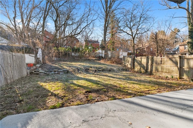 view of yard featuring a residential view and fence