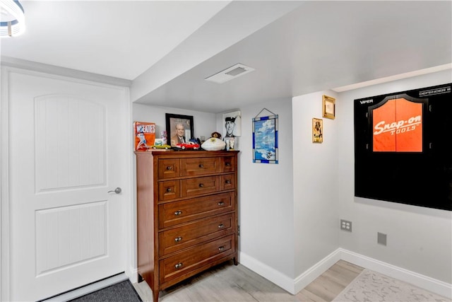 bedroom with visible vents, light wood finished floors, and baseboards