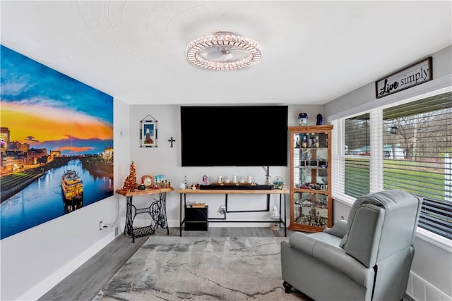 living area featuring wood finished floors and baseboards