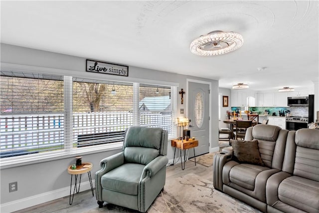 living room featuring baseboards and light wood-style floors